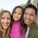 happy parents and young daughter