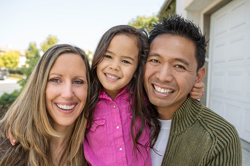 happy parents and young daughter