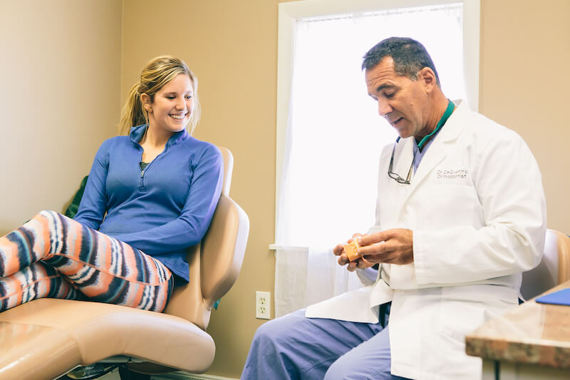 Dr. DeQuattro showing and explaining to his patient